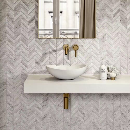 Carrara marble fishbone mosaic bathroom wall installation grey veining