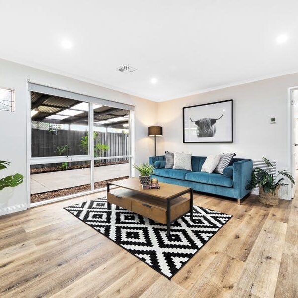 Hybrid 7012 Natural Wild Oak SPC flooring in warm honey tones installed in modern living room with grain detail