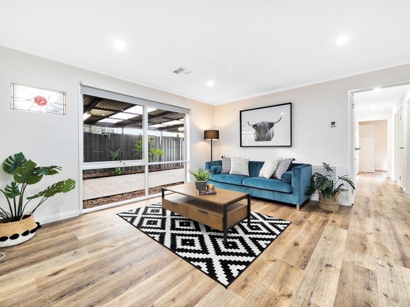 Hybrid 7012 Natural Wild Oak SPC flooring in warm honey tones installed in modern living room with grain detail